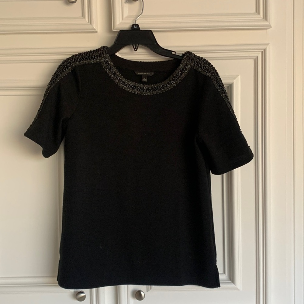Adorable black top with beaded trim. 26 ‘ long and 20 inches across